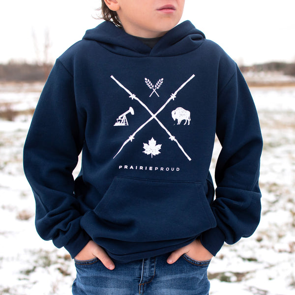 A child wearing a navy blue hooded sweatshirt with a graphic design on it, standing outdoors.