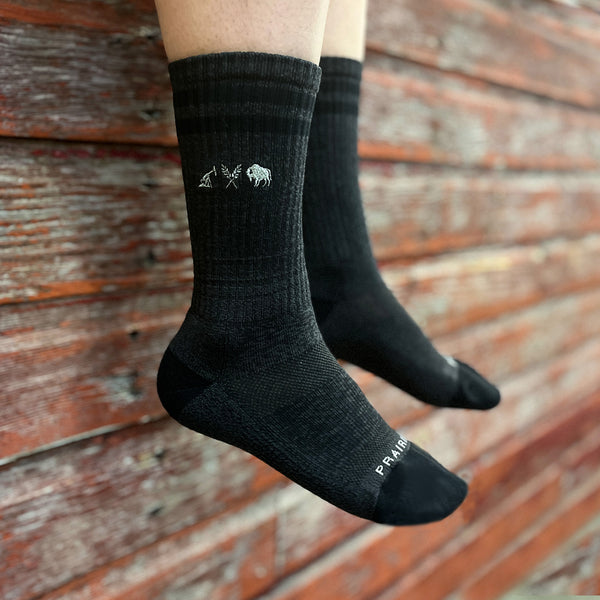 A pair of unisex padded crew socks in charcoal and black, featuring icon logo on the outside ankle area.