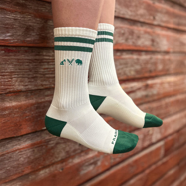 A pair of green padded crew socks with the green icon logo on the outside of the ankle area.