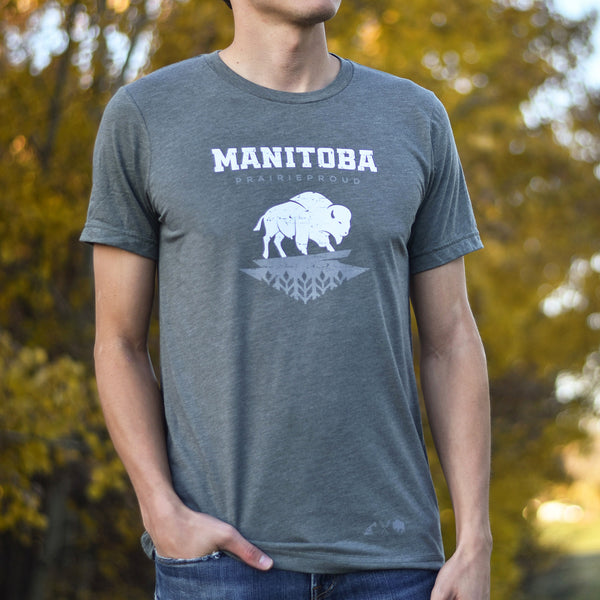 A person wearing a gray crew t-shirt with the text 'MANITOBA prairie proud' and a buffalo logo printed on the front.