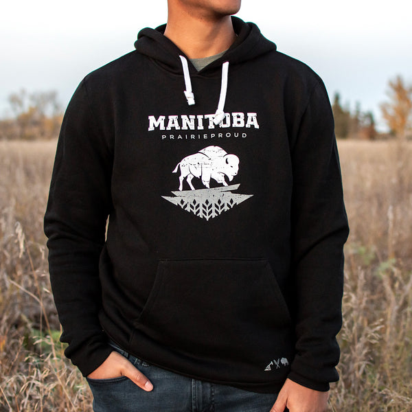 A person wearing a black hoodie with the text 'MANITOBA prairie proud' and a buffalo design on the front.