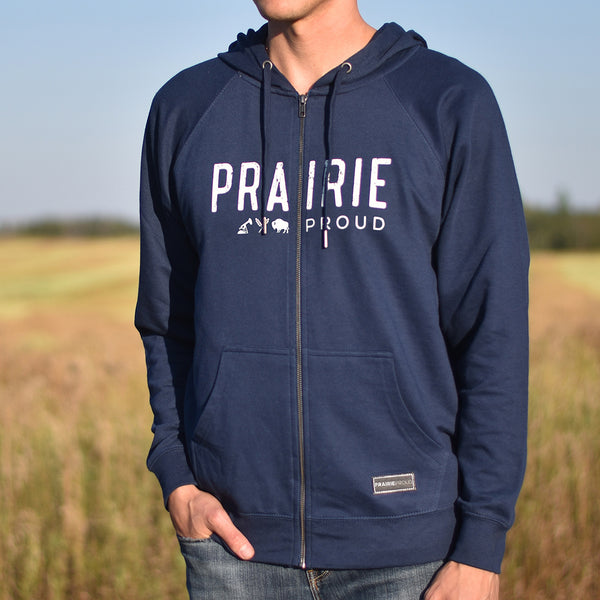 A person wearing a navy blue zip hoodie with the text 'PRAIRIE PROUD' on the front.