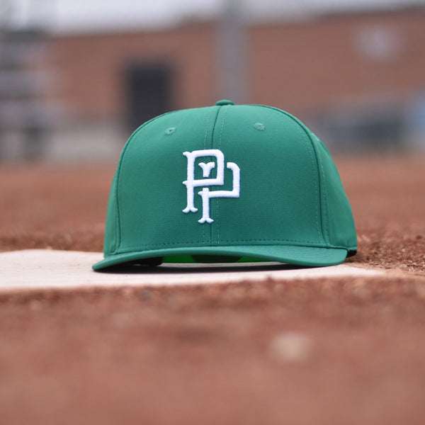A green snapback hat with white embroidery of a monogram on the front.