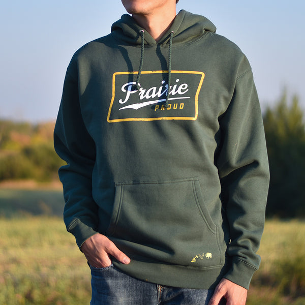 A person wearing a green hoodie with the text 'Prairie Proud' inside of a yellow rectangle.