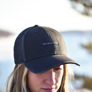 A person wearing a black, distressed baseball cap with the brand name 'PRAIRIE PROUD' visible on the front.