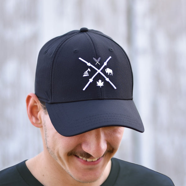 A person wearing a black baseball cap with a barbed wire design in the shape of an 'X'.