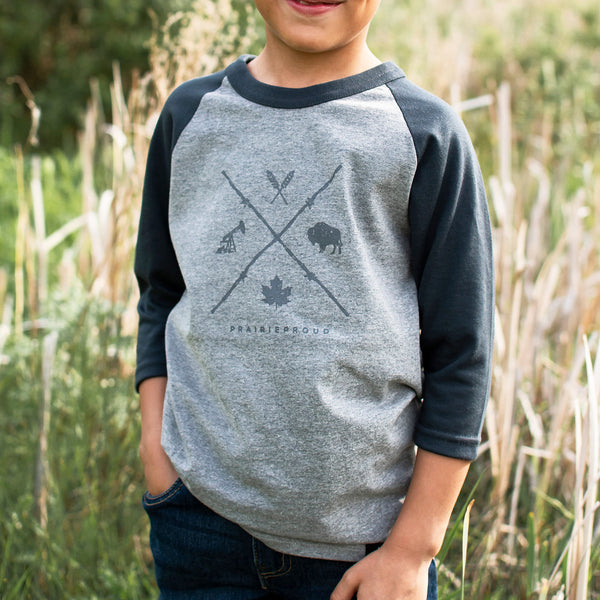 Child wearing a heathered grey and charcoal 3/4 length raglan shirt with various icons and text 'Prairie Proud'.