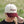 Female wearing a low crown corduroy cap with 'Prairie Proud' text in a natural setting