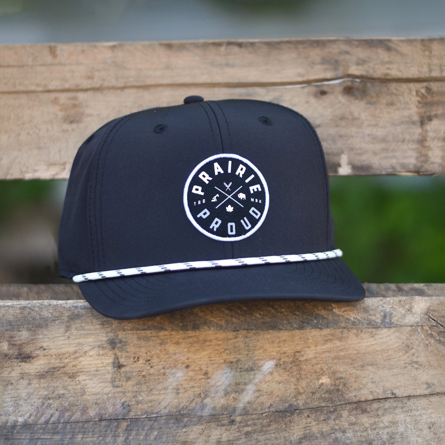 Black cap with a circular logo that says 'Prairie Proud' on the front.