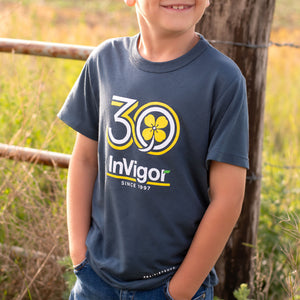 Child wearing a navy slate blue t-shirt with 'InVigor 30' logo in a natural setting