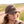 Woman wearing a brown cap ball cap with 